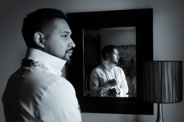 man looking in mirror