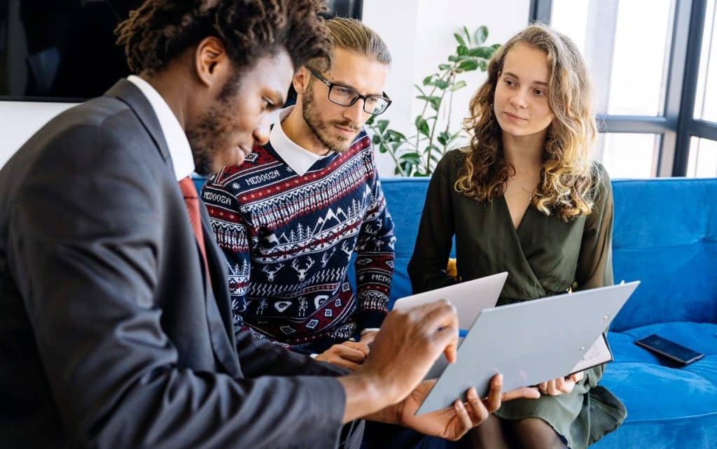 A life insurance agent explaining the benefits of life insurance to a family