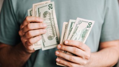 Man holding dollar notes in his hands