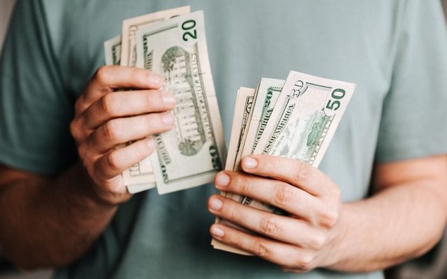 Man holding dollar notes in his hands