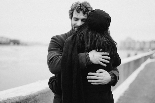 A black and white photo of A couple hugging each other