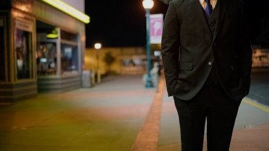 A man wearing a suit standing in a street