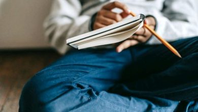 A guy writing something on a copy