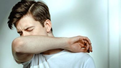 A man sneezing probably because of weak immune system