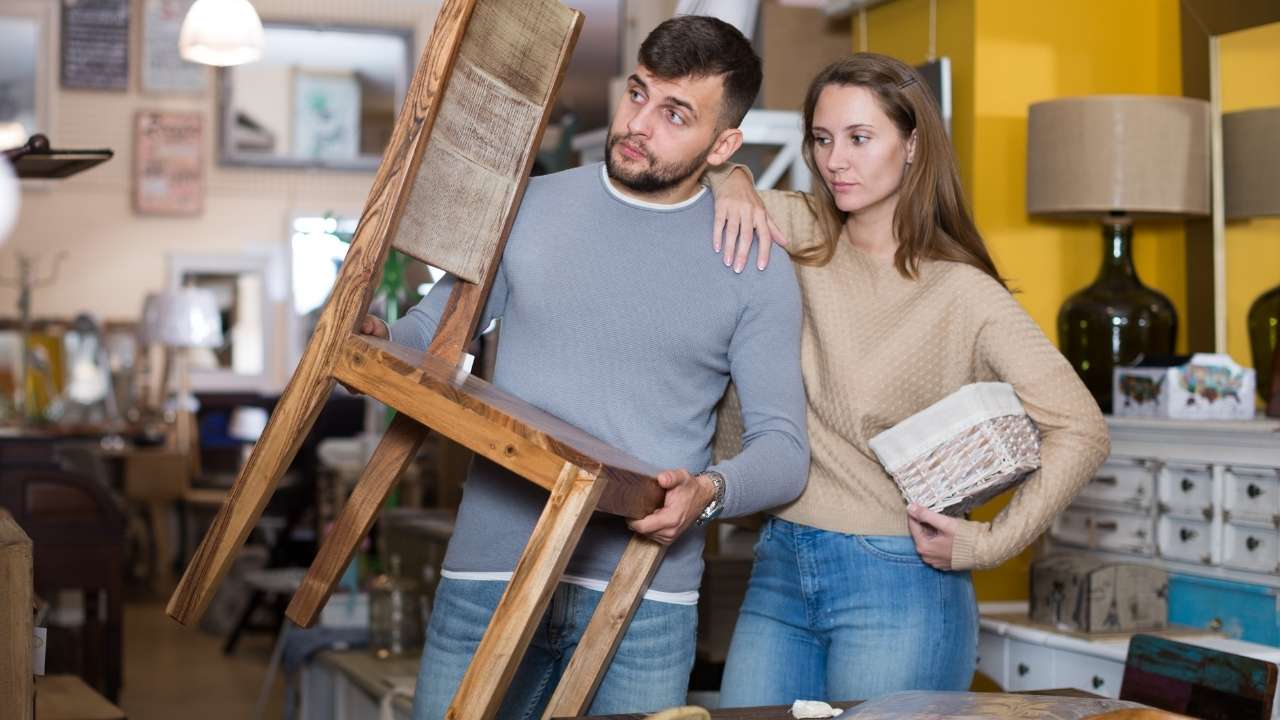 Couple taking apart furniture