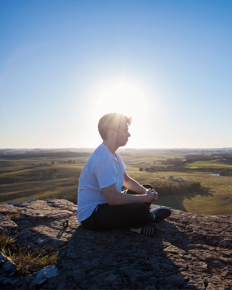 A man sitting on mountain