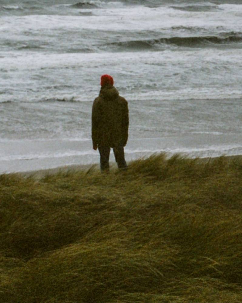 A good enough guy standing near a beach