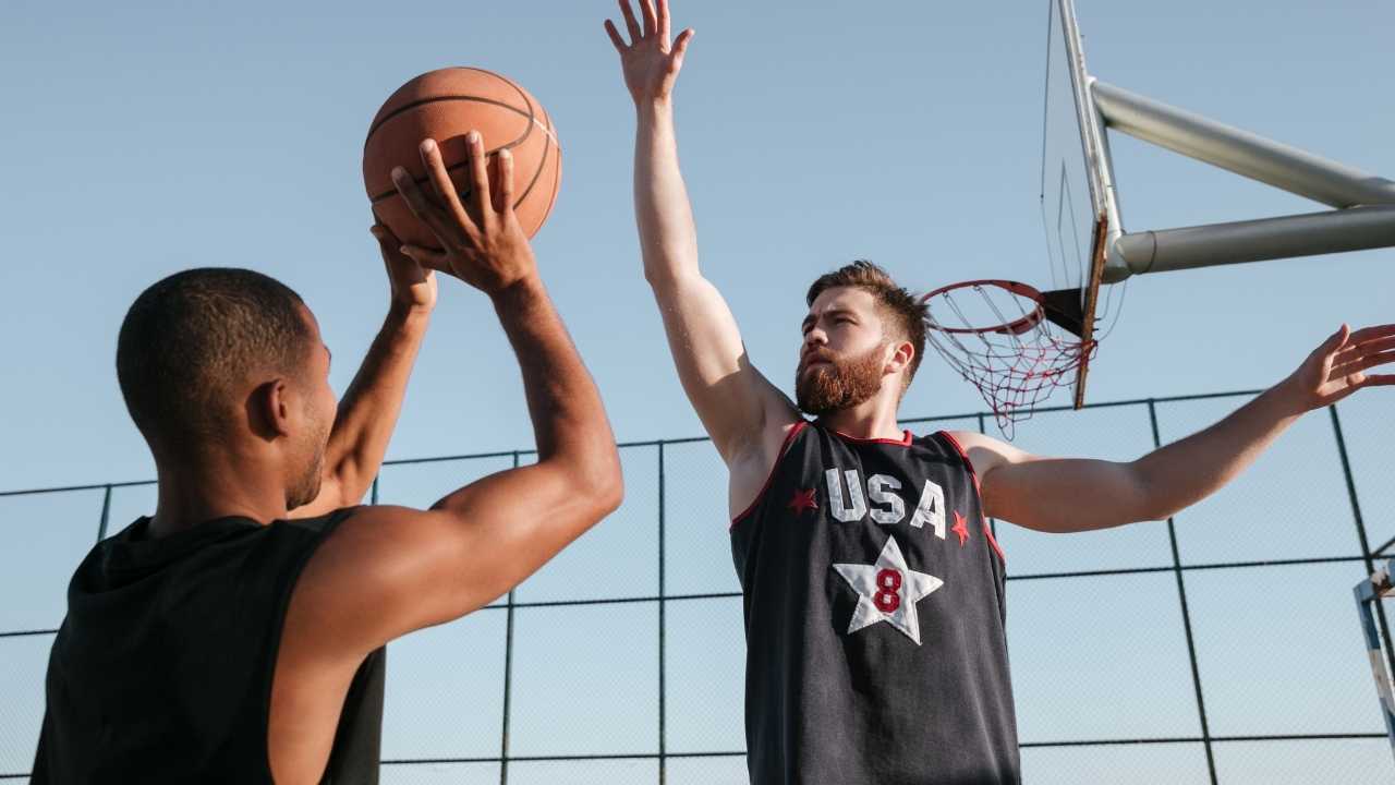 two students playing sports in college