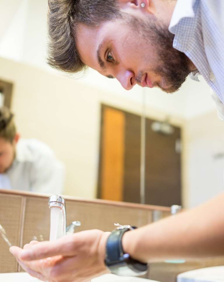 guy washing his face