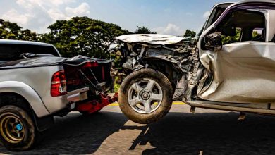 A truck towing a damaged car