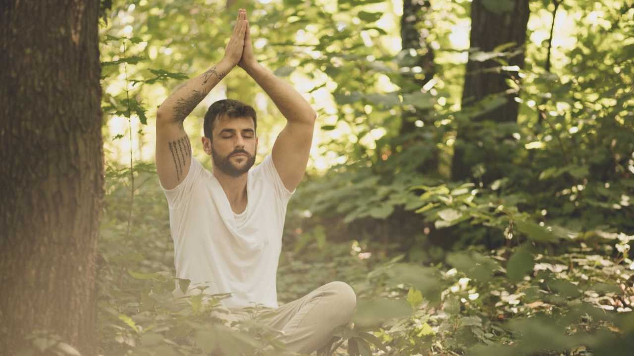 Men in nature doing yoga