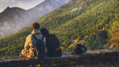 Couple sitting facing the mountains