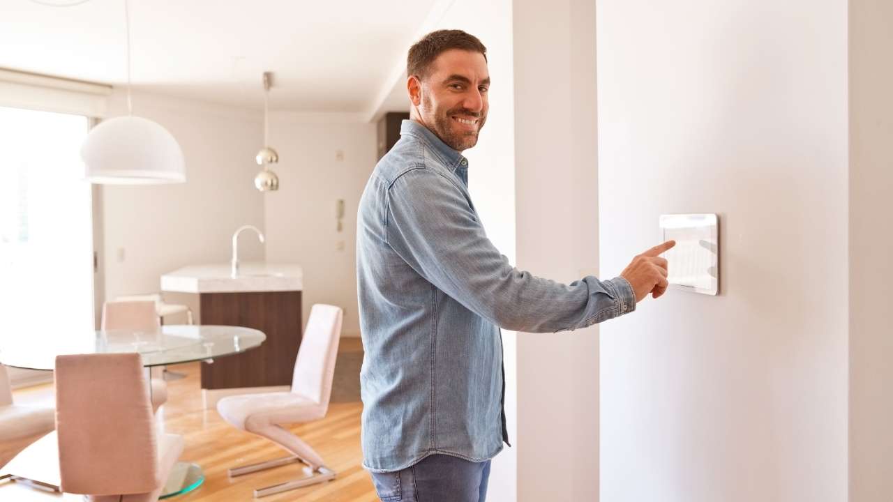 A guy operating Home Security System