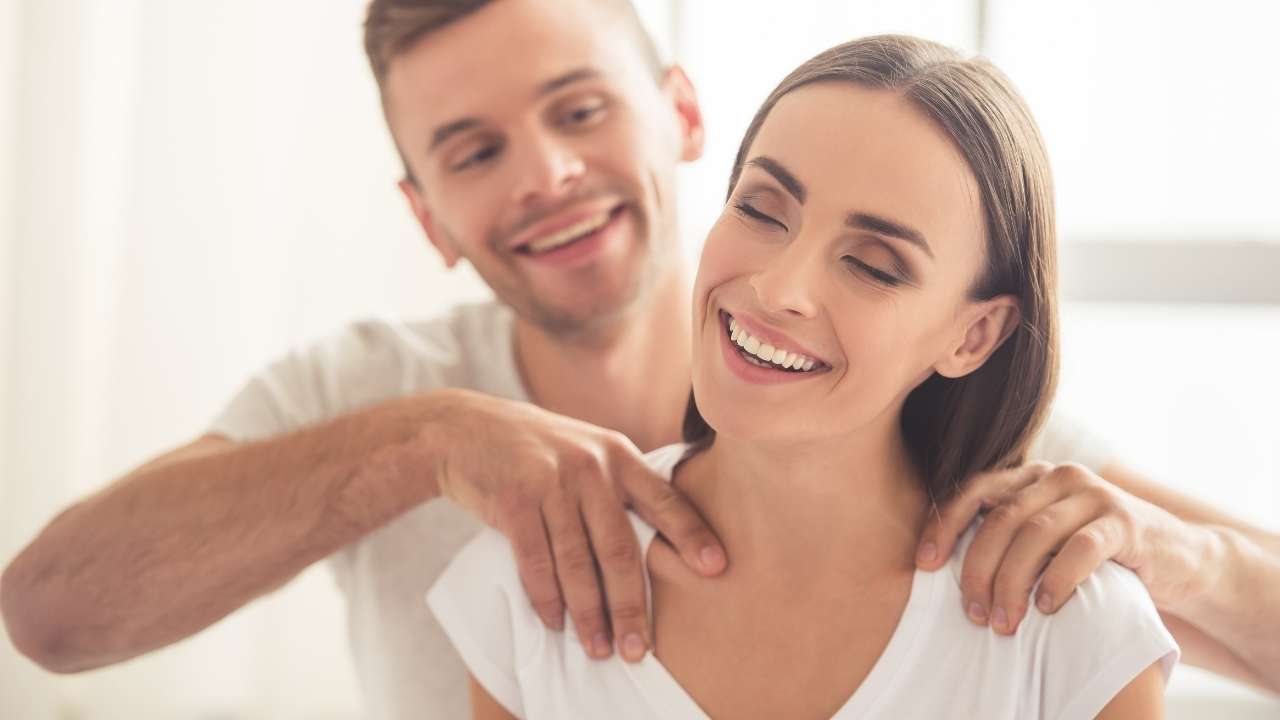 A guy giving a massage to his wife