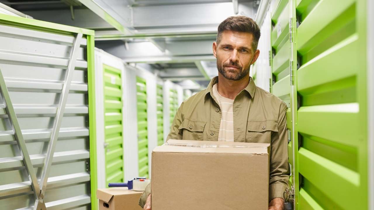 Man loading boxes in a storage unit