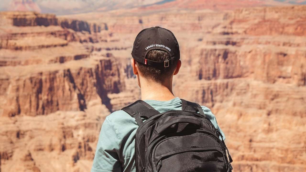 A guy standing at Grand Canyon