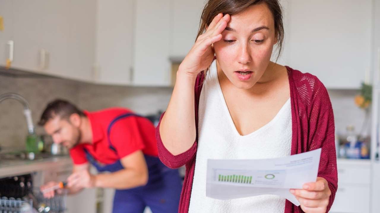 women seeing bill of home restoration