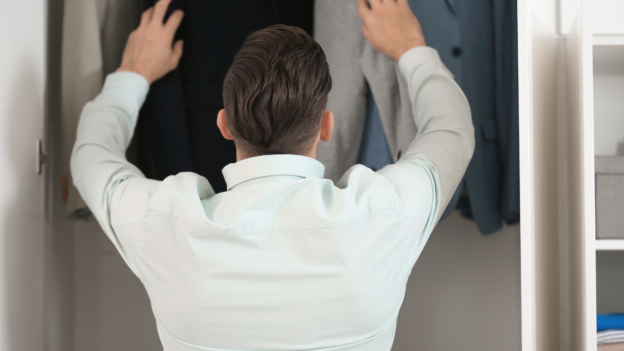 A guy organizing his closet