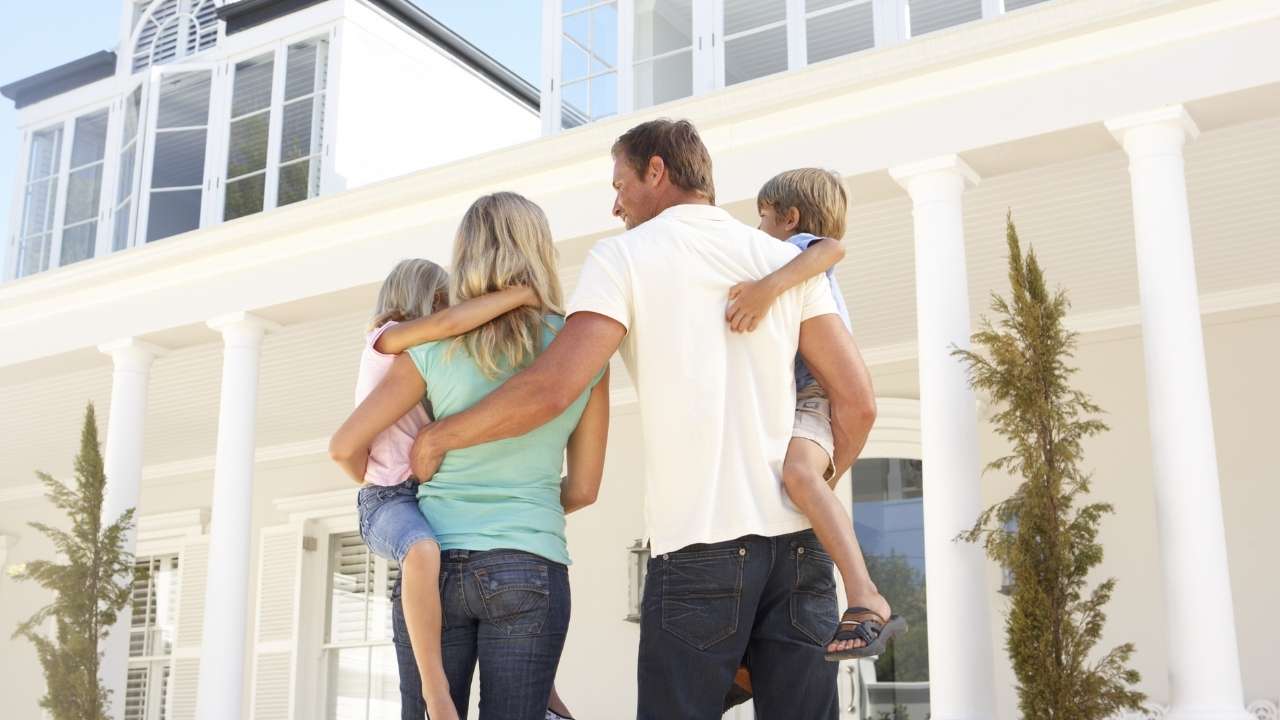 Couple in front of their home