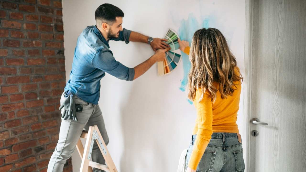 Couple selecting paint for their home