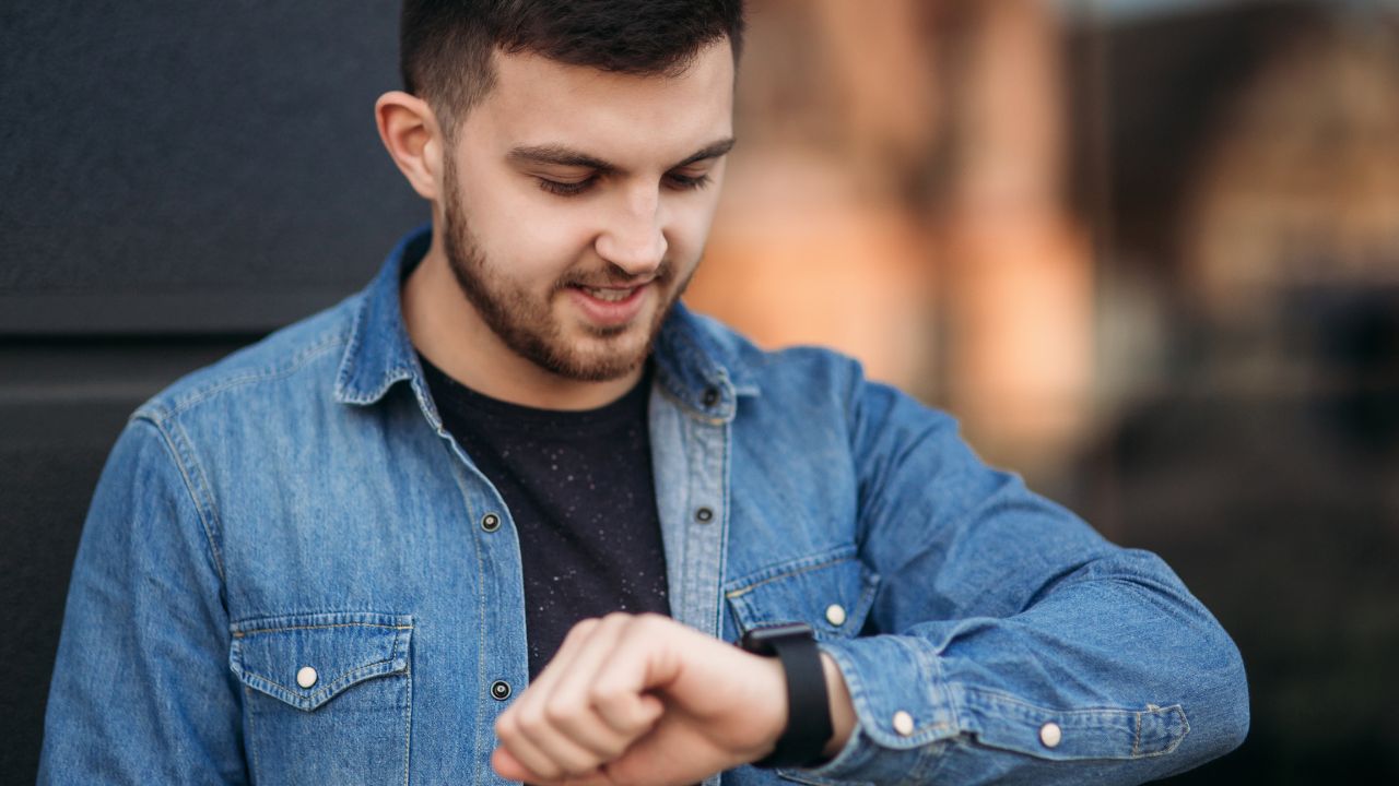 Guy looking at his apple watch