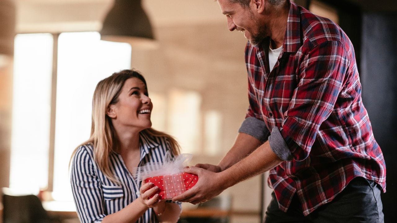 a guy giving gift to his girl 