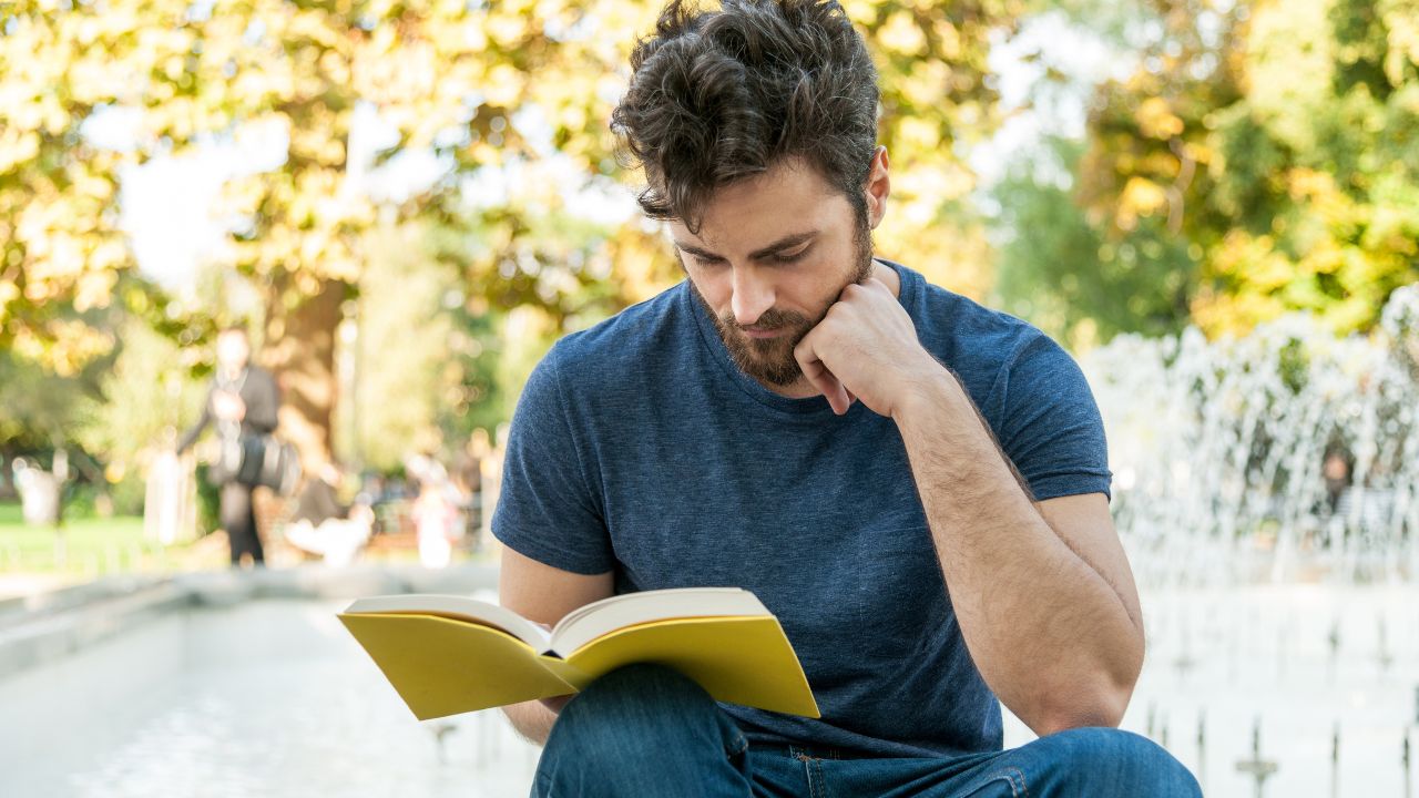 guy man reading book 