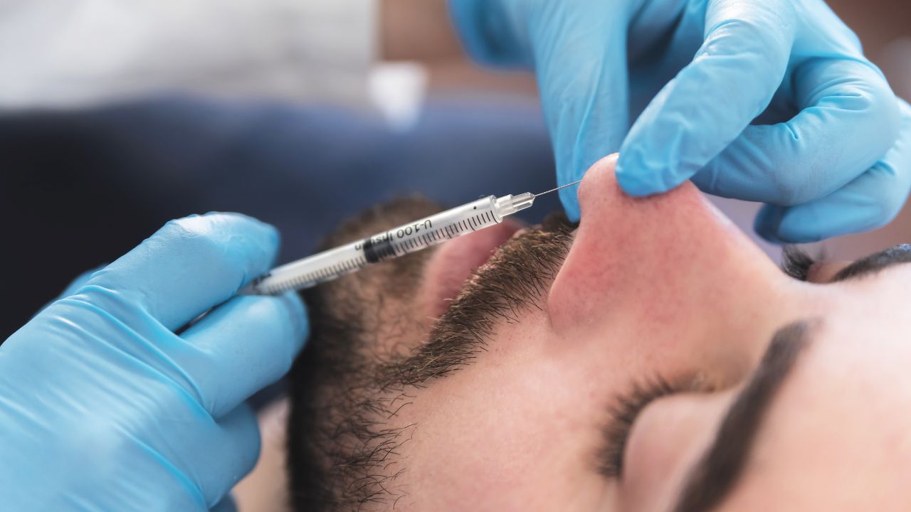 A guy getting Nose Fillers done