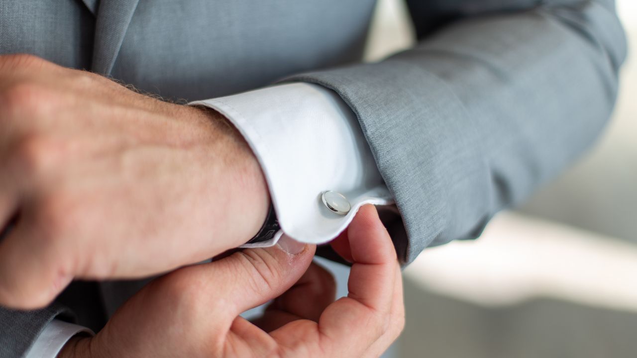 Man in grey suit and shirt with cufflinks