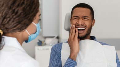 guy in dental chair suffering tooth pain