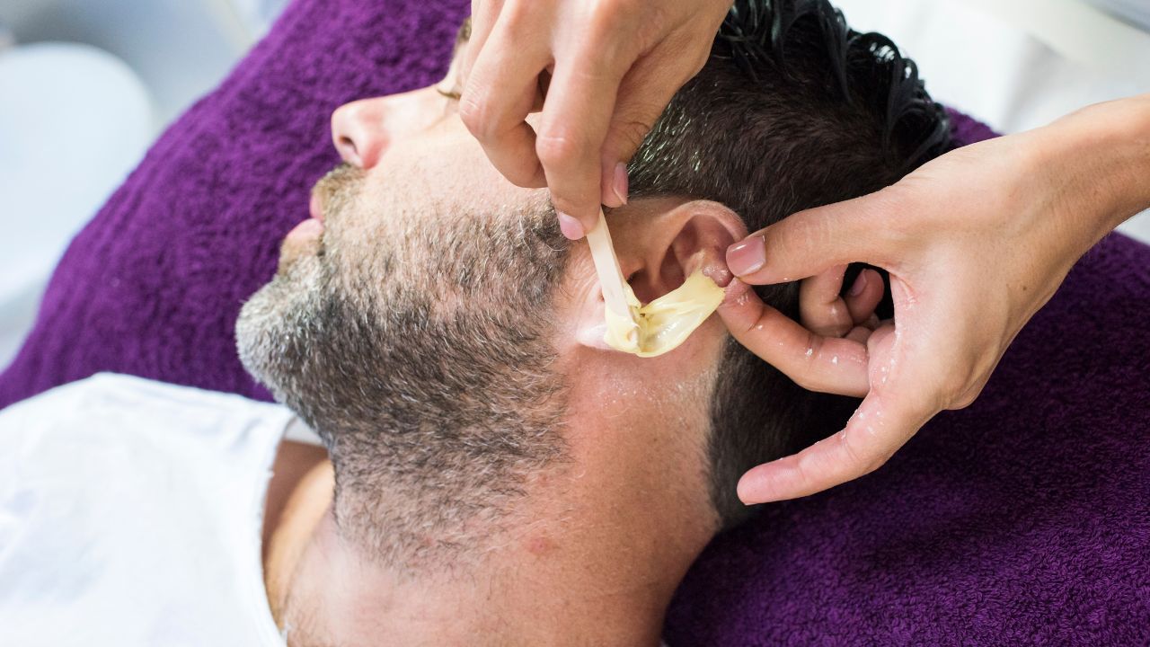 male getting ear waxed