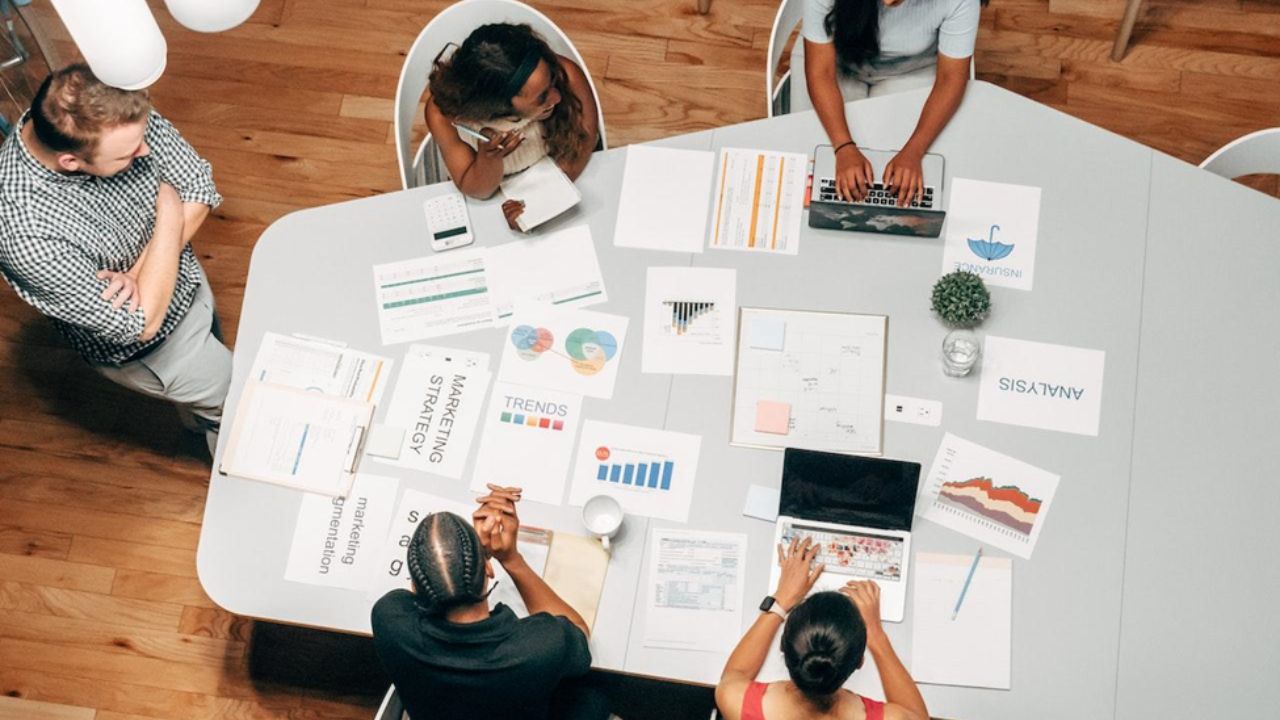 marketing people sitting beside a table