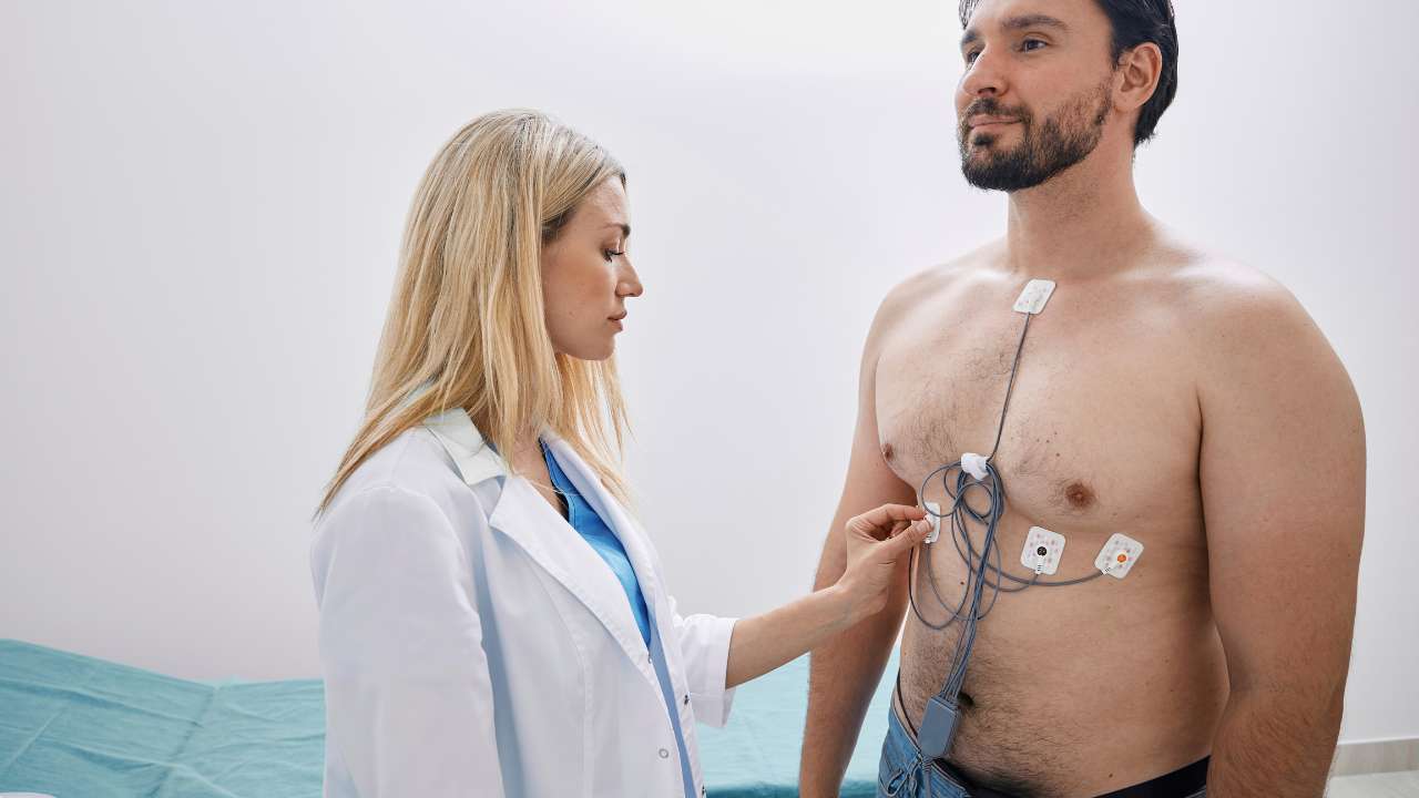 doctor checking a mans ecg