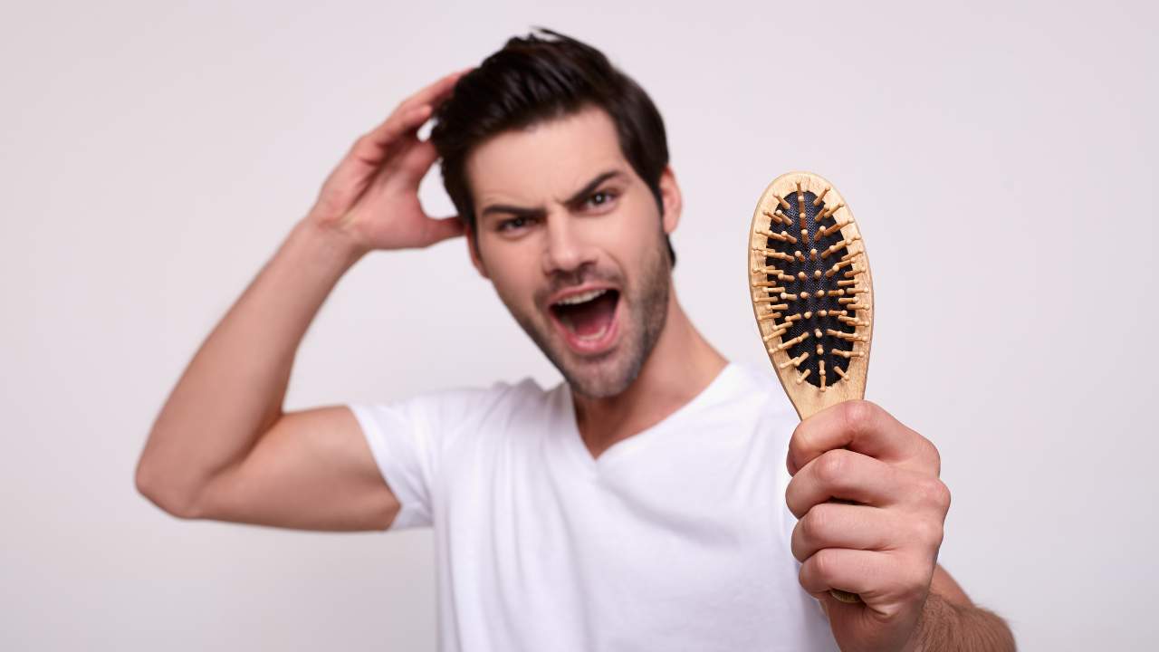 guy having broken hair in the comb