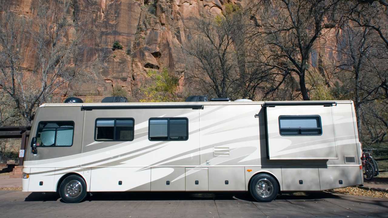 clean luxury RV parked outside in woods