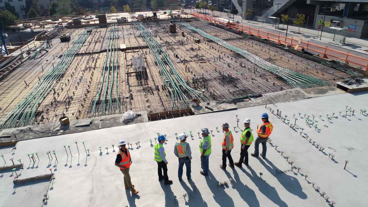 construction workers standing on white field
