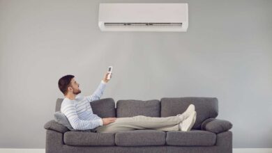 man adjusting ac temperature