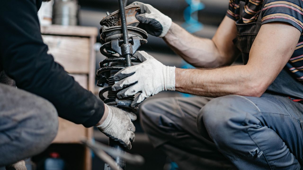 mechanic checking car suspension