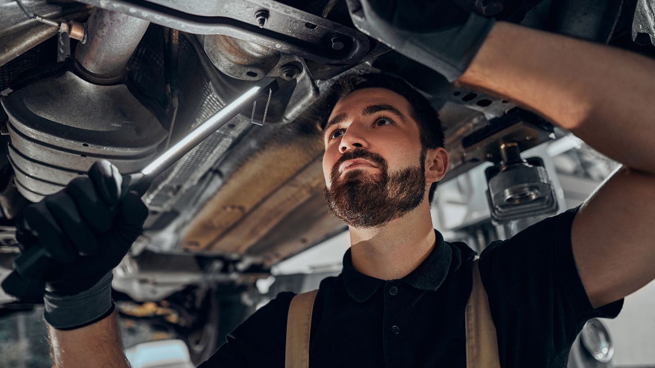 mechanic checking car suspension