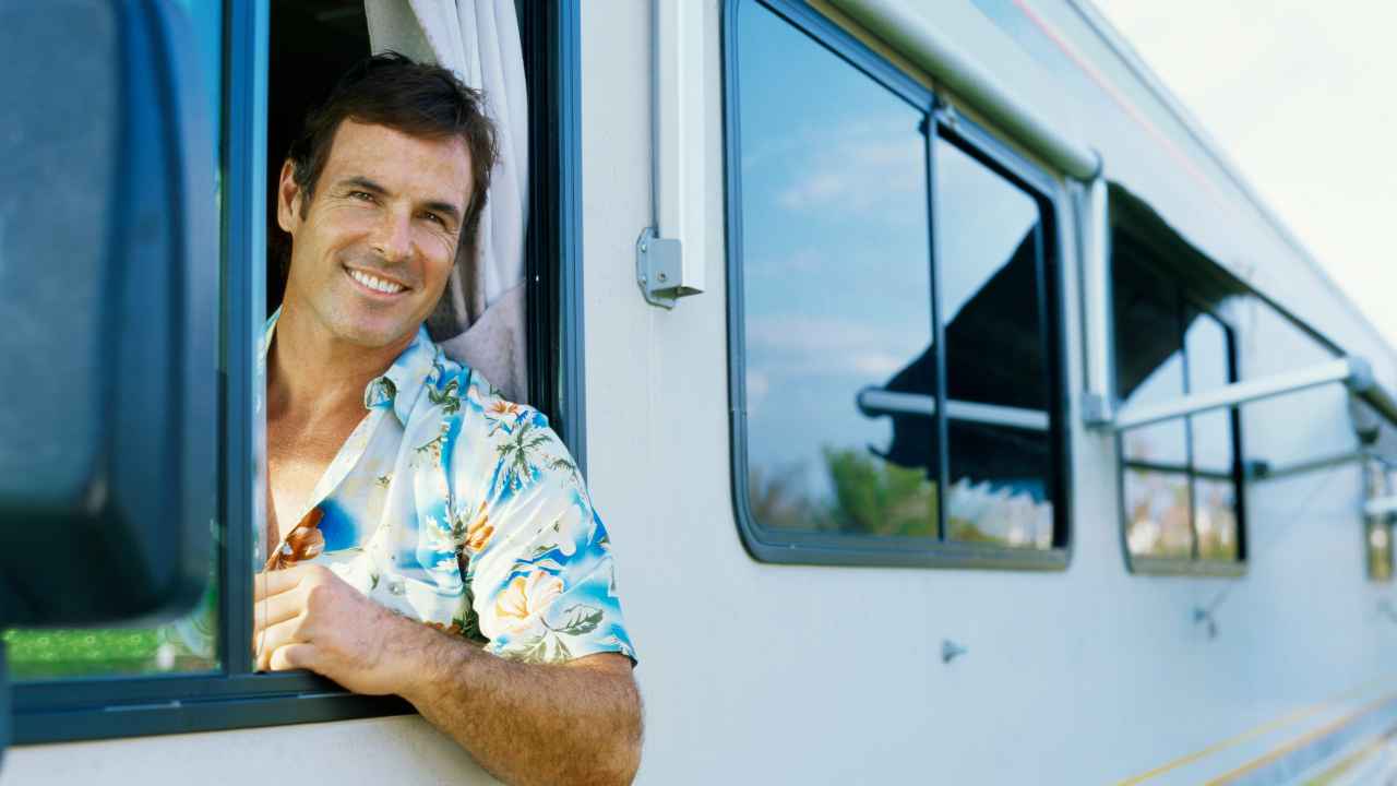 man looking out of caravan