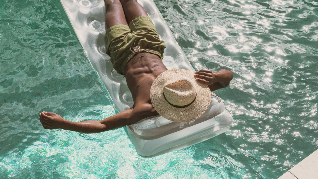 A guy relaxing in pool