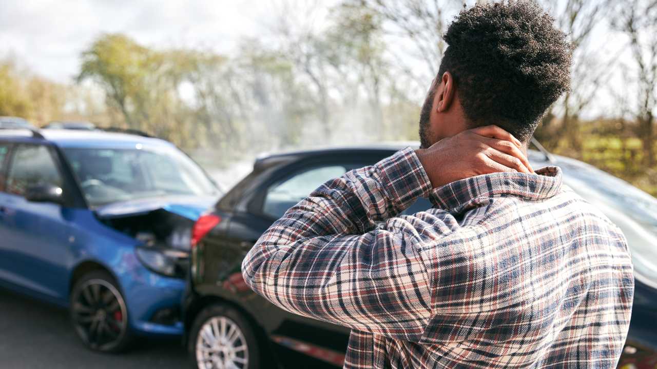 A guy seeing is car after accident