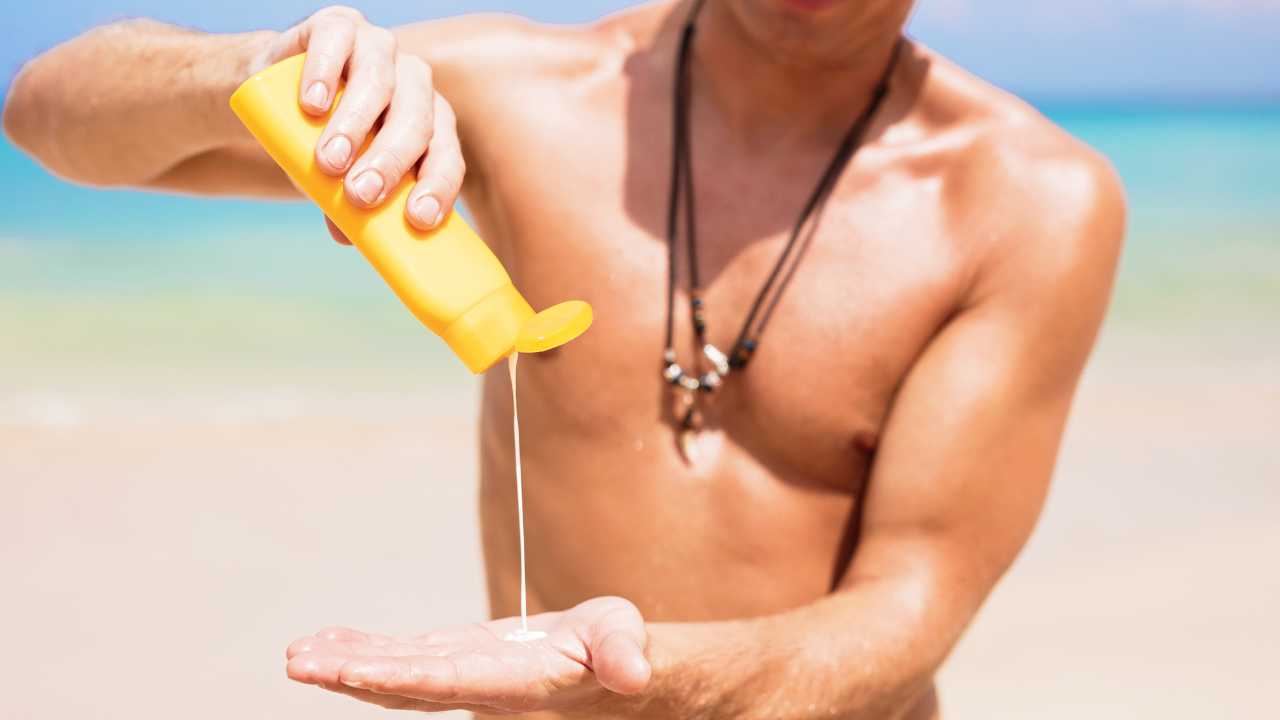 man applying sun screen