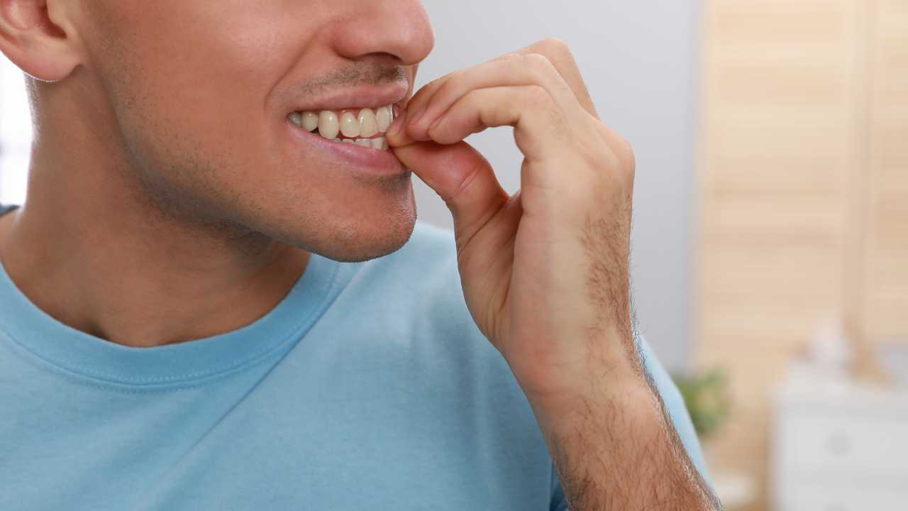 man biting nails