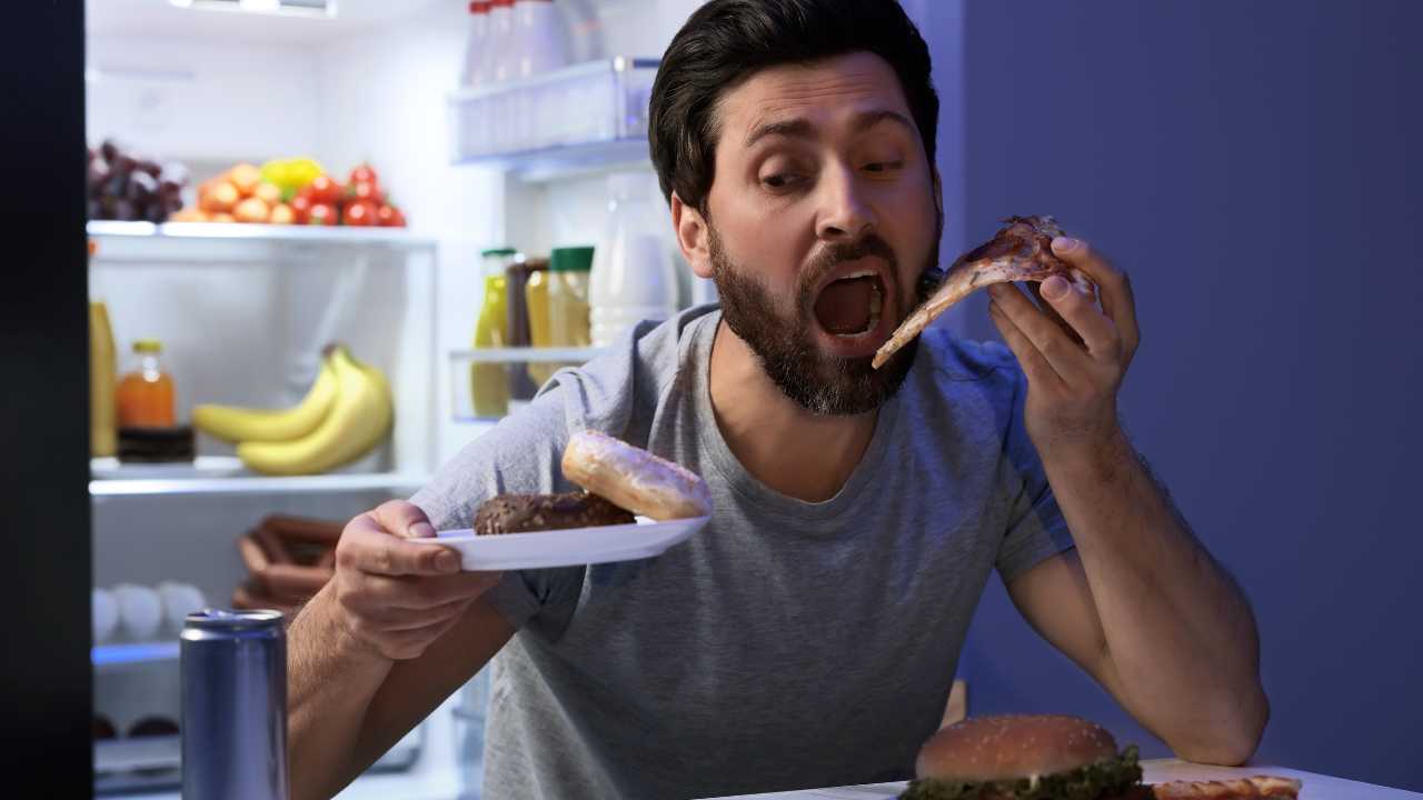 man eating junk food