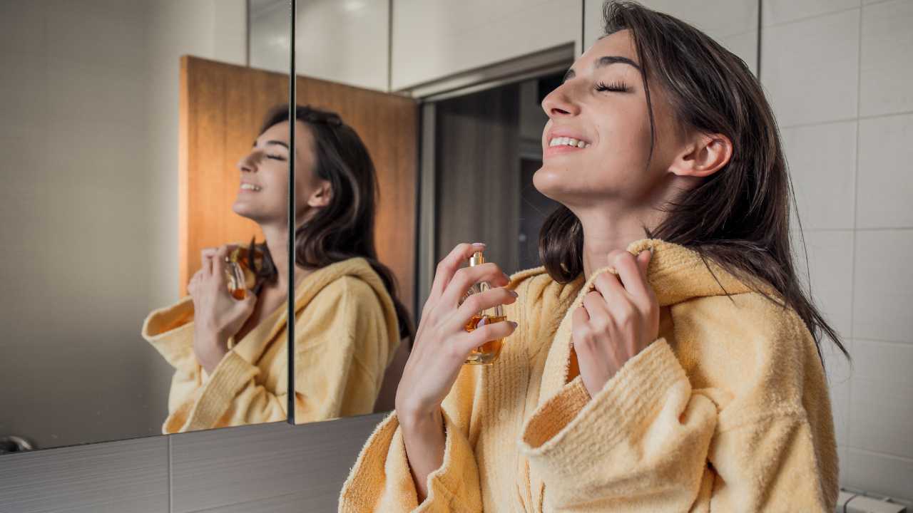 woman applying perfume