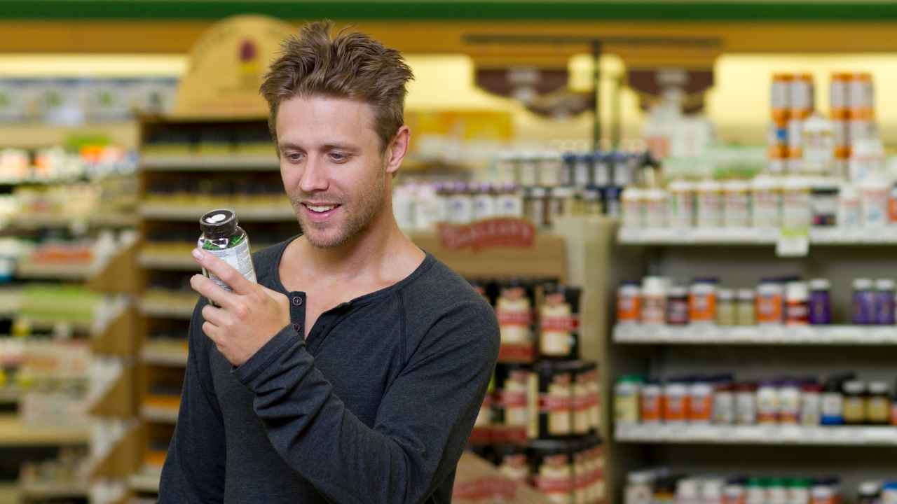 a guy looking at a supplement