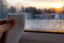 person wiping off Window Condensation